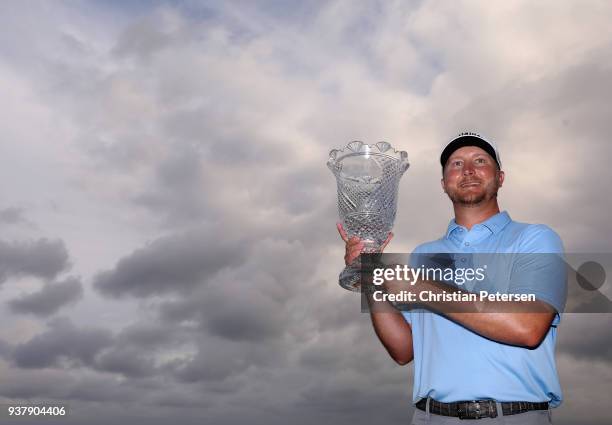 Brice Garnett poses with the trophy after putting in to win on the 18th green during the final round of the Corales Puntacana Resort & Club...