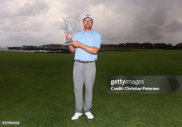 Brice Garnett poses with the trophy after putting in to win on the 18th green during the final round of the Corales Puntacana Resort & Club...