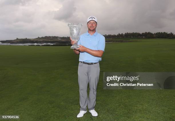 Brice Garnett poses with the trophy after putting in to win on the 18th green during the final round of the Corales Puntacana Resort & Club...