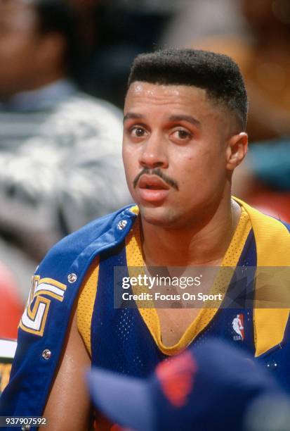 Mahmoud Abdul-Rauf of the Denver Nuggets looks on from the bench against the Washington Bullets during an NBA basketball game circa 1991 at the...