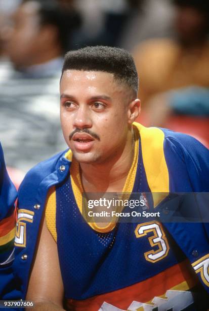 Mahmoud Abdul-Rauf of the Denver Nuggets looks on from the bench against the Washington Bullets during an NBA basketball game circa 1991 at the...
