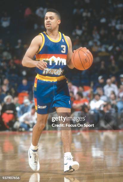 Mahmoud Abdul-Rauf of the Denver Nuggets dribbles the ball against the Washington Bullets during an NBA basketball game circa 1992 at the Capital...
