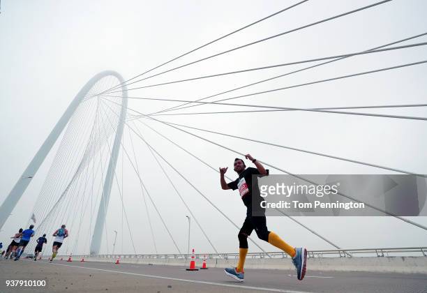 Participants run across the Margaret Hunt Hill Bridge during the Toyota Rock 'N' Roll Dallas Half Marathon on March 25, 2018 in Dallas, Texas.