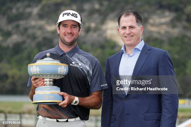 Bubba Watson of the United States celebrates with Michael Dell and the Walter Hagen Cup after defeating Kevin Kisner of the United States 7&6 to win...