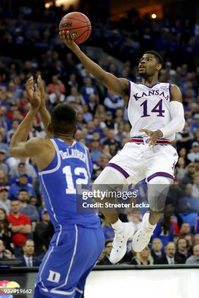 Malik Newman of the Kansas Jayhawks shoots the ball against Javin DeLaurier of the Duke Blue Devils during overtime in the 2018 NCAA Men's Basketball...