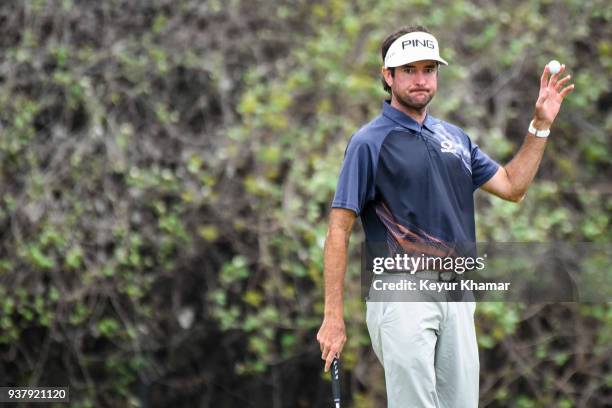 Bubba Watson celebrates his 7&6 victory and waves his ball to fans on the 12th hole green following the championship match at the World Golf...