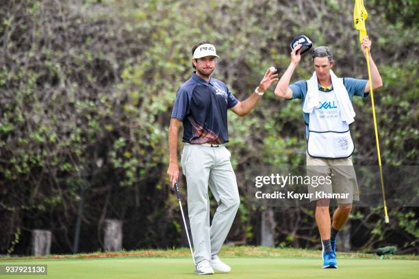 Bubba Watson celebrates his 7&6 victory with his caddie Ted Scott and waves his ball to fans on the 12th hole green following the championship match...