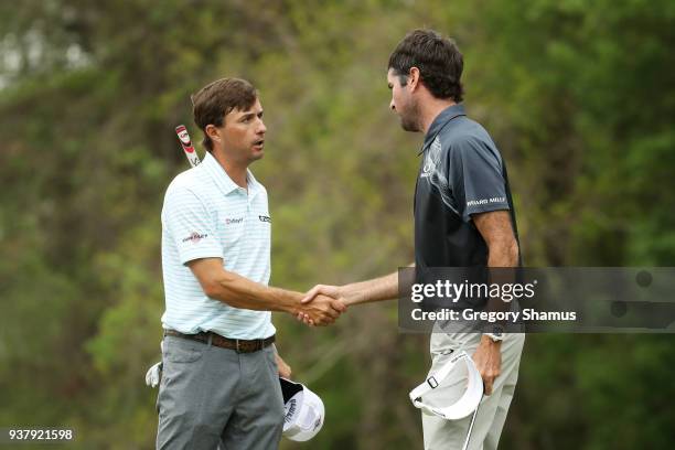 Bubba Watson of the United States shakes hands with Kevin Kisner of the United States after defeating him 7&6 to win on the 12th green during the...