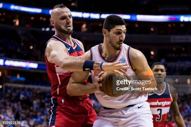 Marcin Gortat of the Washington Wizards defends Enes Kanter of the New York Knicks during the first half at Capital One Arena on March 25, 2018 in...