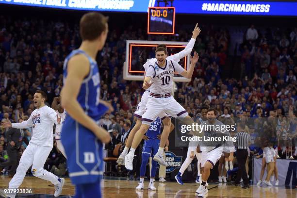 Sviatoslav Mykhailiuk of the Kansas Jayhawks celebrates with teammates following their 85-81 OT win against the Duke Blue Devils during the 2018 NCAA...