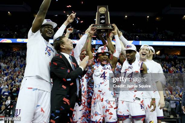 Udoka Azubuike, head coach Bill Self, Devonte' Graham and Malik Newman of the Kansas Jayhawks celebrate with the tropy after defeating the Duke Blue...