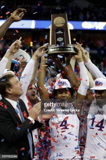 Head coach Bill Self, Devonte' Graham and Malik Newman of the Kansas Jayhawks celebrate with the tropy after defeating the Duke Blue Devils with a...