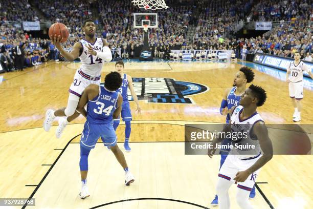 Malik Newman of the Kansas Jayhawks attempts a lay up against Wendell Carter Jr of the Duke Blue Devils in the 2018 NCAA Men's Basketball Tournament...