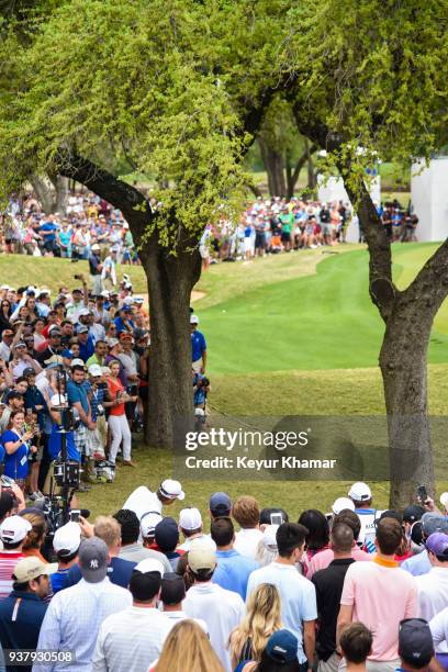 Kevin Kisner chips a shot between the trees to the sixth hole green as fans watch during the championship match at the World Golf Championships-Dell...