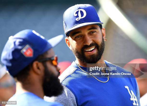 Matt Kemp talks with Andrew Toles of the Los Angeles Dodgers before the spring training game against the Los Angeles Angels of Anaheim at Angel...