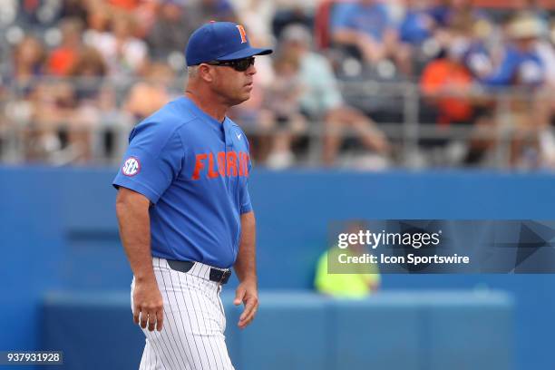 Gators Head Coach Kevin O'Sullivan walks out to the mound to talk to his pitcher during the college baseball game between the Arkansas Razorbacks and...