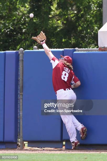 Eric Cole of Arkansas attempts to make a catch at the wall but Cole came up short as Jonathan India's fly ball hit the top of the wall and India got...