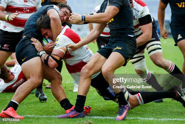 Franco Mostert of Lions is tackled by Agustin Creevy of Jaguares during a match between Jaguares and Lions as part of the sixth round of Super Rugby...