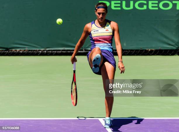 Monica Puig of Puerto Rico kicks the ball to a ballkid during her match with Maria Sakkari of Greece during Day 7 of the Miami Open Presented by Itau...