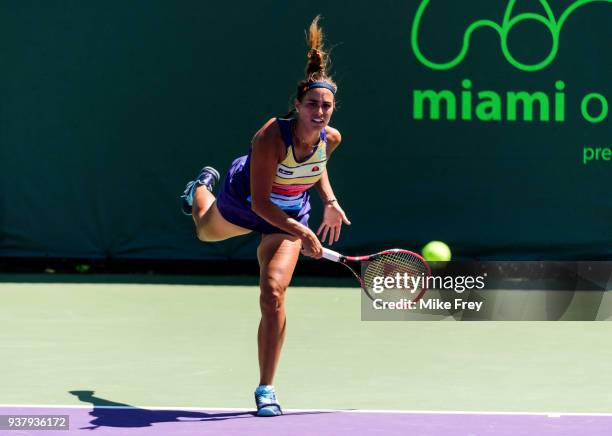 Monica Puig of Puerto Rico serves during her match with Maria Sakkari of Greece during Day 7 of the Miami Open Presented by Itau at Crandon Park...