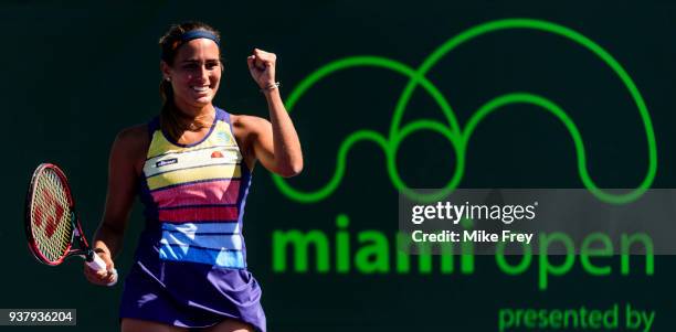 Monica Puig of Puerto Rico celebrates winning her match against Maria Sakkari of Greece 6-3 7-5 during Day 7 of the Miami Open Presented by Itau at...