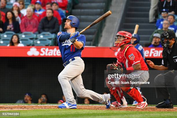 Los Angeles Dodgers Infield Logan Forsythe hits a long fly ball during a preseason MLB game between the Los Angeles Dodgers and the Los Angeles...