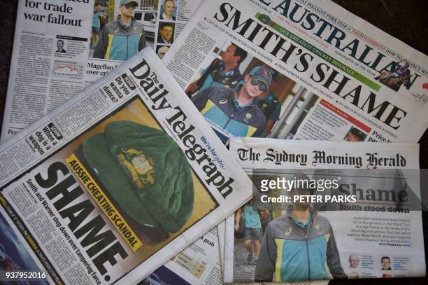 Photo shows Australian cricket captain Steve Smith on the front pages of the major newspapers in Sydney on March 26, 2018. Australia's cricketers...
