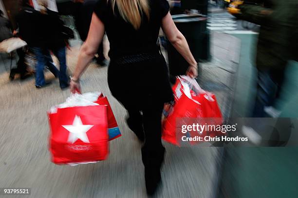 Woman carries bags from Macy's department store in midtown Manhatann December 3, 2009 in New York City. Retail sales declined 0.3 percent, with...