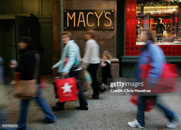 Shoppers and pedestrians walk past an extrance to Macy's December 3, 2009 in New York City. Retail sales declined 0.3 percent, with Macy's dopping...