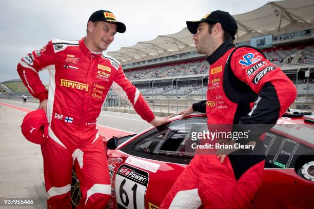 Toni Vilander of Finland , and Miguel Molina, of Spain, talk on pit road after winning the GT race during the Pirelli World Challenge Grand Prix of...