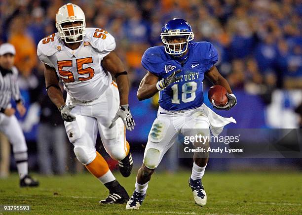 Randall Cobb of the Kentucky Wildcats runs with the ball while defended by Dan Williams of the Tennessee Volunteers during the SEC game at...