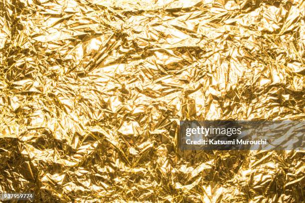 golden winkled foil texture background - foil foto e immagini stock