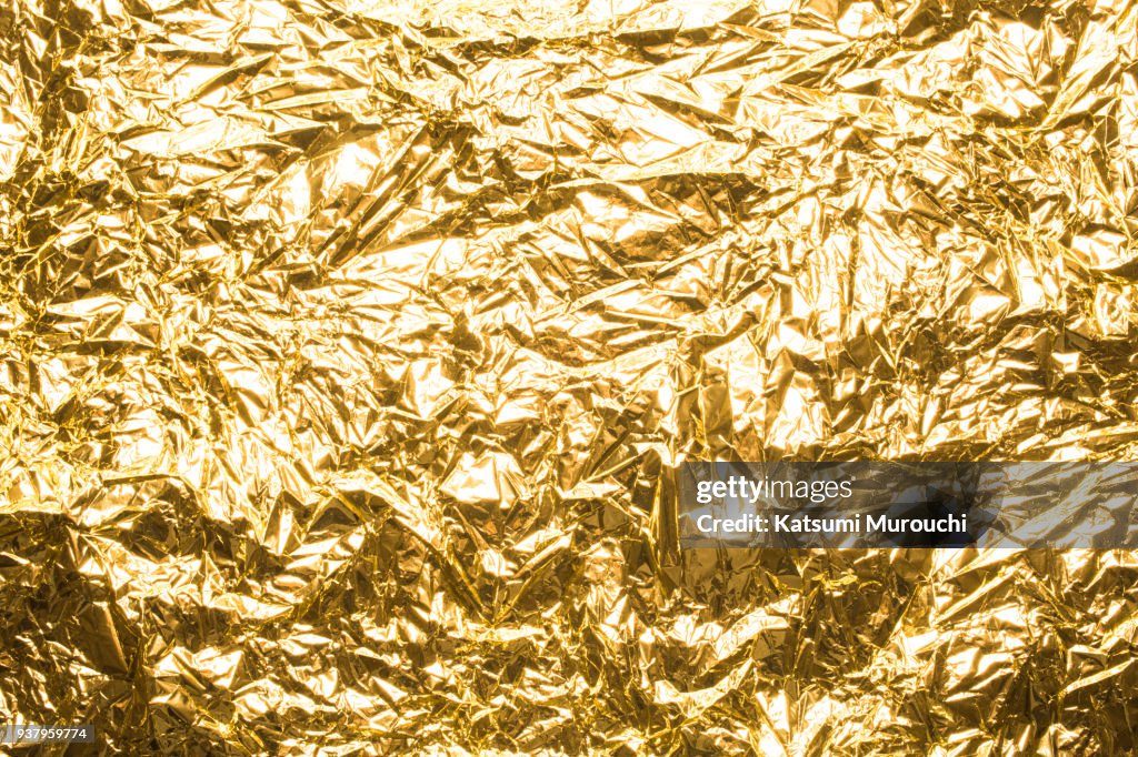 Golden winkled foil texture background