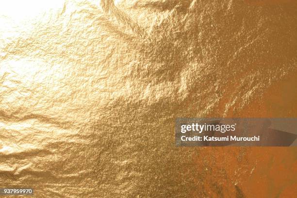 golden foil texture background - gold foil stock-fotos und bilder