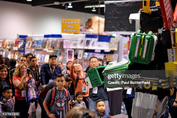 Attendees take photos of a Transformer cosplayer during WonderCon 2018 at Anaheim Convention Center on March 25, 2018 in Anaheim, California.