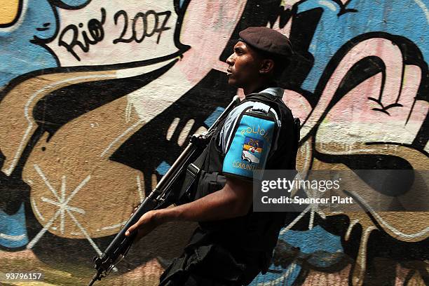 Police officer patrols the recently "pacified" Babilônia slum, or favela, on December 3, 2009 in Rio de Janeiro, Brazil. Babilônia is one of a number...