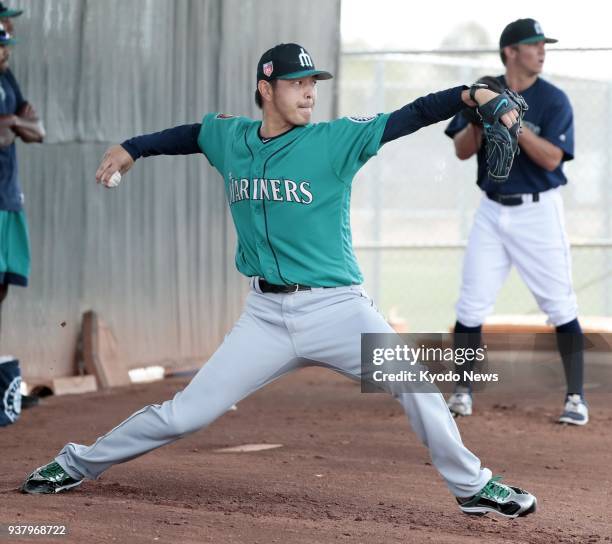 Seattle Mariners pitcher Hisashi Iwakuma throws in the bullpen during training in Peoria, Arizona, on March 25, 2018. ==Kyodo