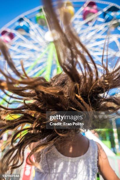 a girl with her hair blowing in the wind. - nassau county bildbanksfoton och bilder