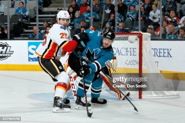 Nick Shore of the Calgary Flames defends Mikkel Boedker of the San Jose Sharks at SAP Center on March 24, 2018 in San Jose, California.