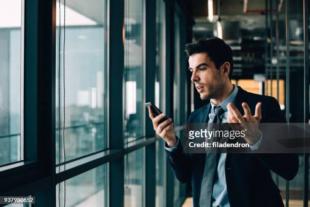 confused phone communication - rich fury stock pictures, royalty-free photos & images