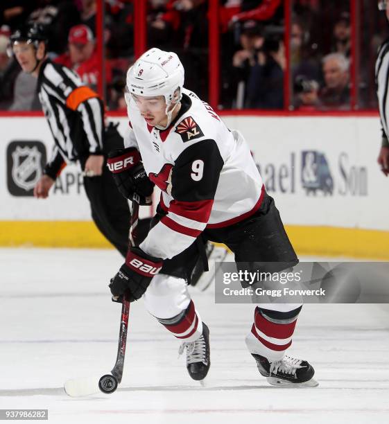 Clayton Keller of the Arizona Coyotes gathers up a loose puck during an NHL game against the Carolina Hurricanes on March 22, 2018 at PNC Arena in...