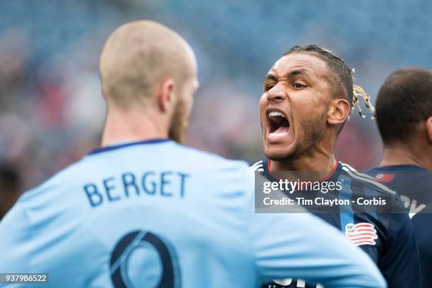 March 24: Juan Agudelo of New England Revolution communicates with his goalkeeper while defending a free kick watched by Jo Inge Berget of New York...