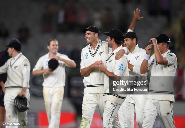 New Zealand bowlers Tim Southee and Colin de Grandhomme celebrate with team mates after victory on day five of the First Test Match between the New...