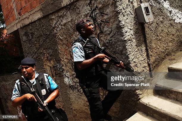 Police officers patrol the recently "pacified" Babilônia slum, or favela, on December 3, 2009 in Rio de Janeiro, Brazil. Babilônia is one of a number...