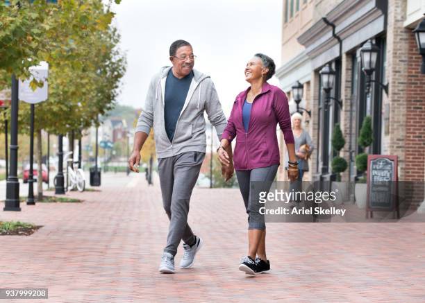 senior couple walking for exercise - nice old town stock pictures, royalty-free photos & images
