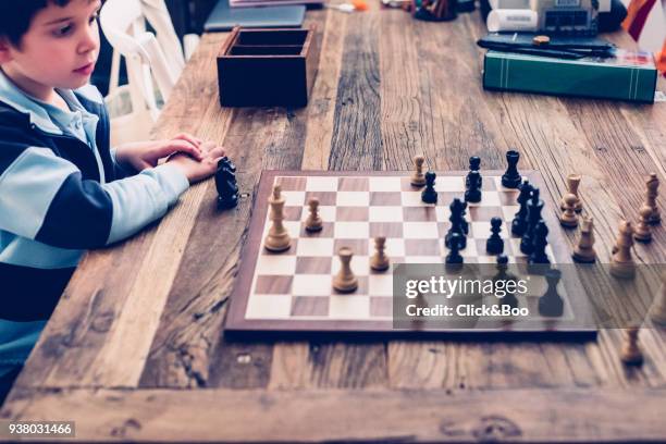 little boy playing chess - click&boo stock pictures, royalty-free photos & images