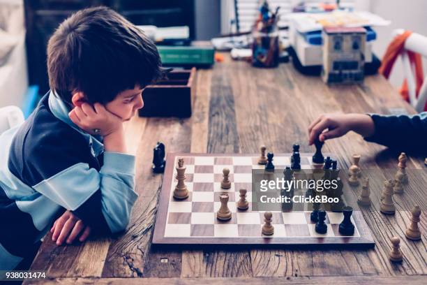 little boy playing chess - click&boo bildbanksfoton och bilder