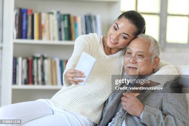 father and daugther taking selfie at home - vietnamese ethnicity stock pictures, royalty-free photos & images