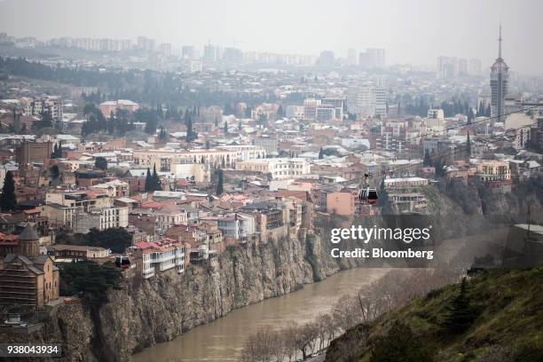 Cable cars travel over Mtkvari River and Old Town up to Narikala Fortress in Tbilisi, Georgia, on Saturday, March 24, 2018. Georgias gross domestic...