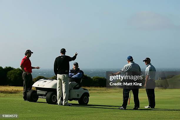 Mathew Goggin, Geoff Ogilvy, Peter O'Malley and Nathan Green speak to tournament director Andrew Langford-Jones before play was suspended due to...